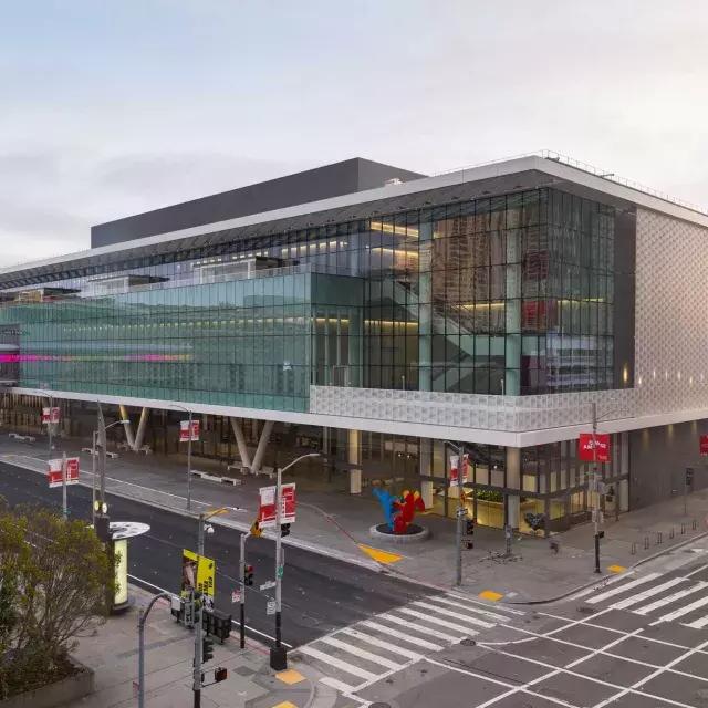 A wide shot of the glassy, modern Moscone Center South building.